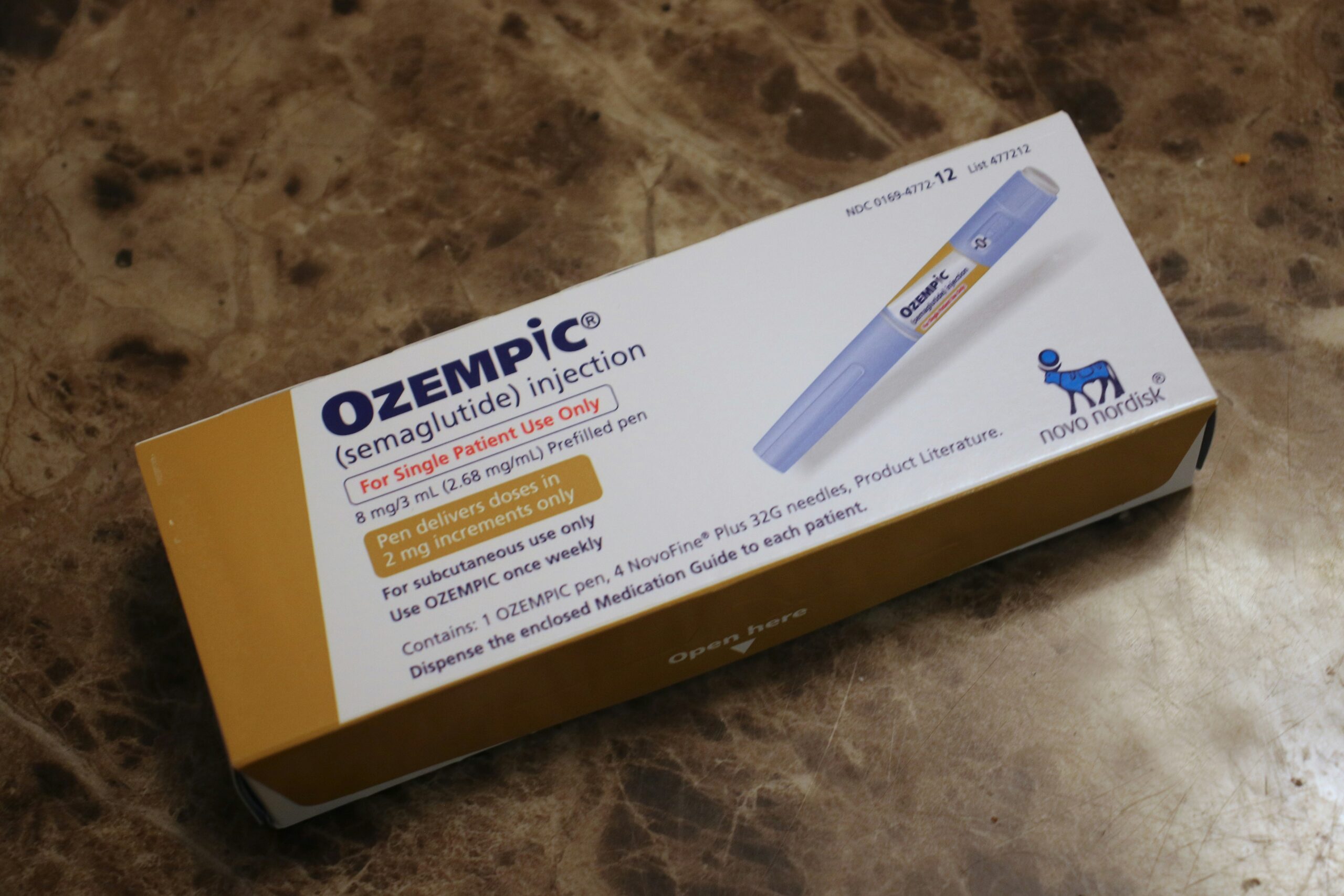 A box of Ozempic (semaglutide) injection pens placed on a marble countertop. The packaging includes dosage information and branding from Novo Nordisk.